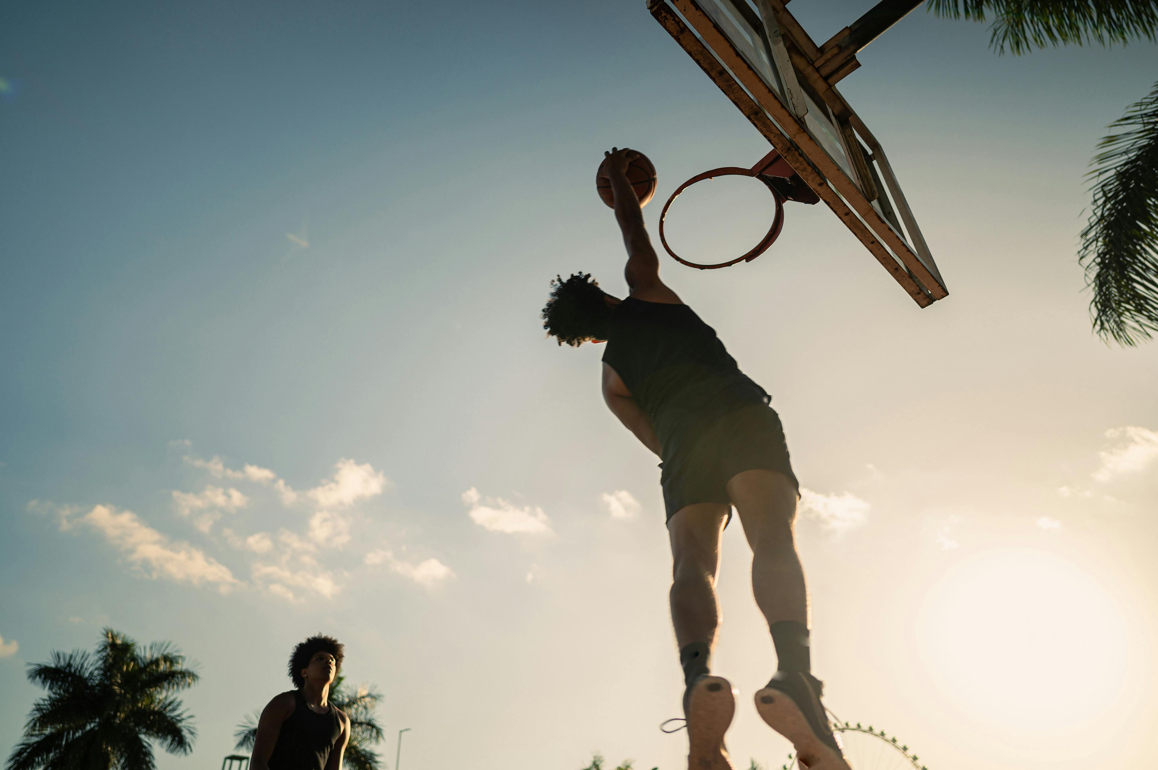 Basketball player dunking outside
